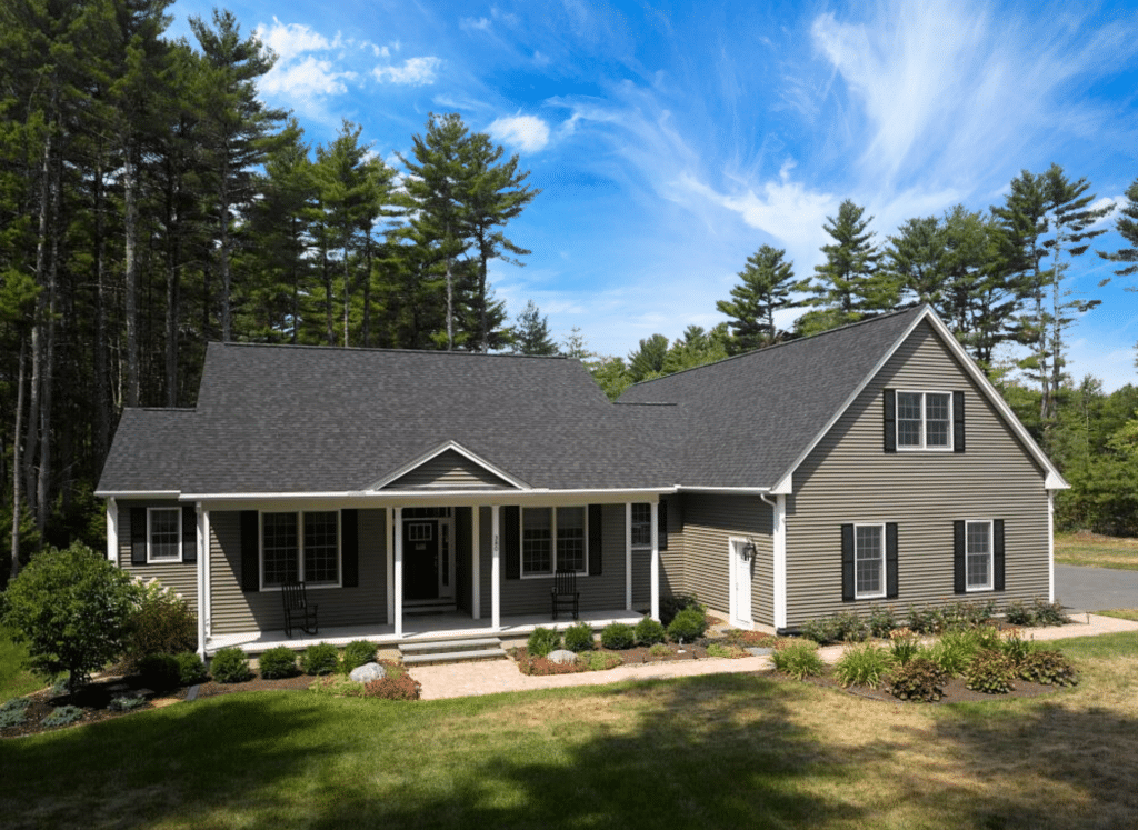 A professional roofer in a safety harness installs CertainTeed asphalt shingles on a steep roof under a clear blue sky.