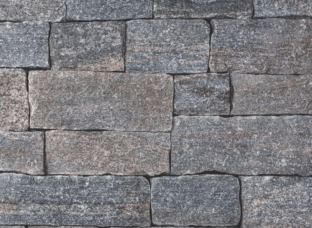 A close-up view of a granite stone siding wall featuring rectangular, rough-textured stones in dark gray tones with subtle hints of brown and red, arranged in a natural pattern.