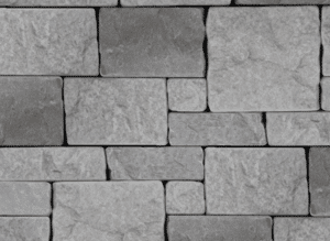 A close-up view of a rectangular stone veneer wall featuring precisely cut gray stones in varying shades, arranged in a uniform pattern for a modern and refined look.