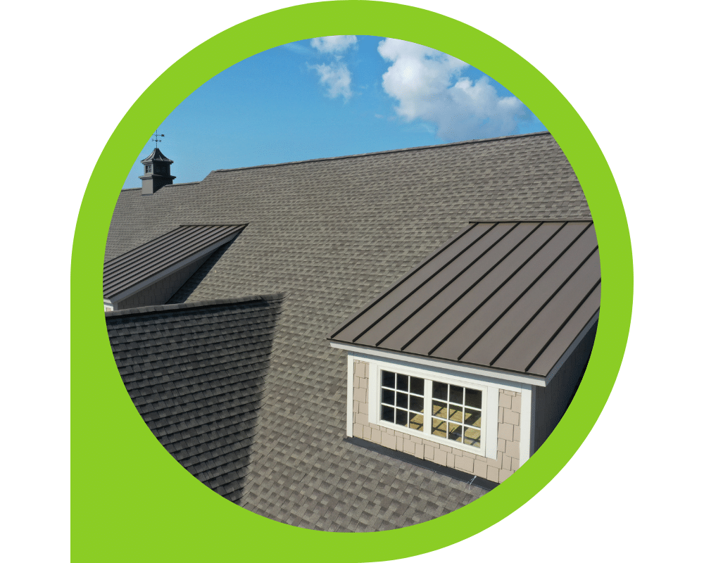 Architectural shingle roof with standing seam metal roofing sections on residential home.