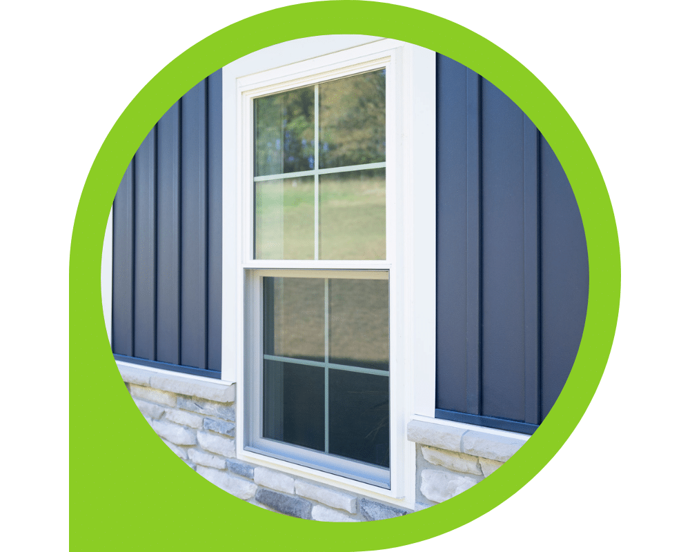 White double-hung window installed on blue vertical siding exterior.